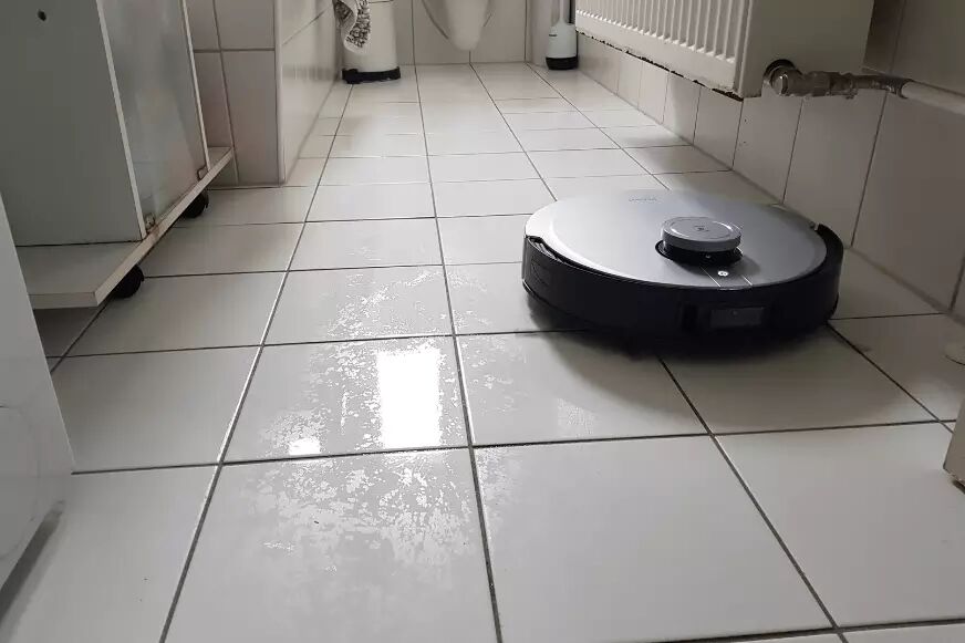 The Ecovacs Deebot X1 OMNI mops the bathroom floor
